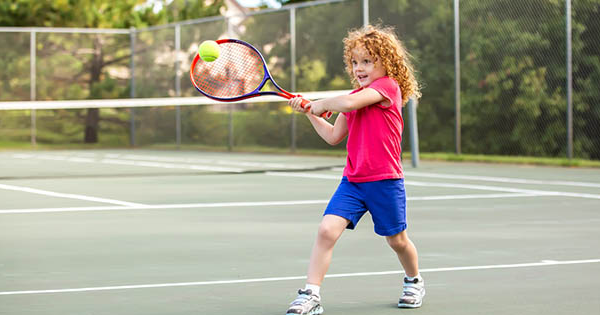 little boy play tennis