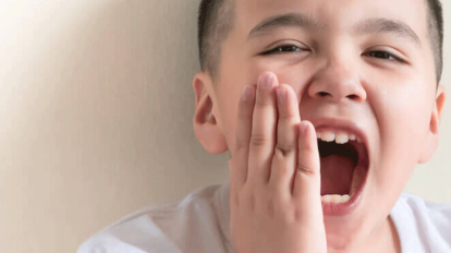 boy kid suffering from toothache