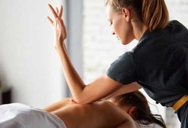 therepist giving massage to patient