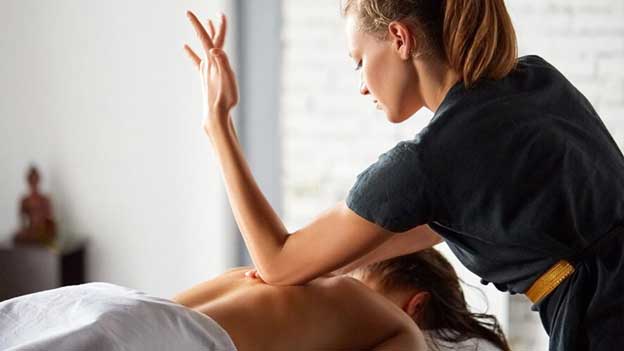 therepist giving massage to patient